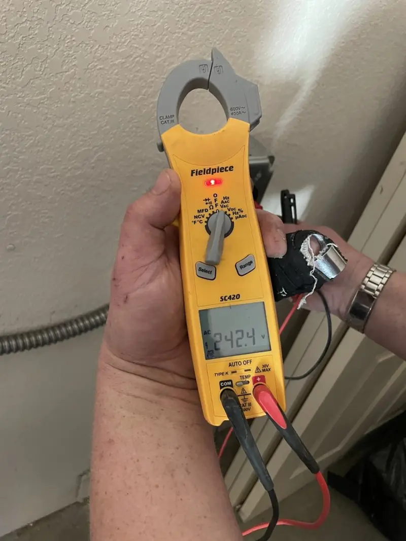 Voltage testing with clamp meter during Electrical Installation Services in Farmington